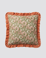 Orange frill cushion cover with a floral block print and a rust ruffled edge, front view