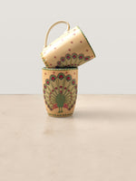 Mor Bagh Dawn porcelain coffee mugs stacked, peacock with a fanned tail on a soft yellow ground