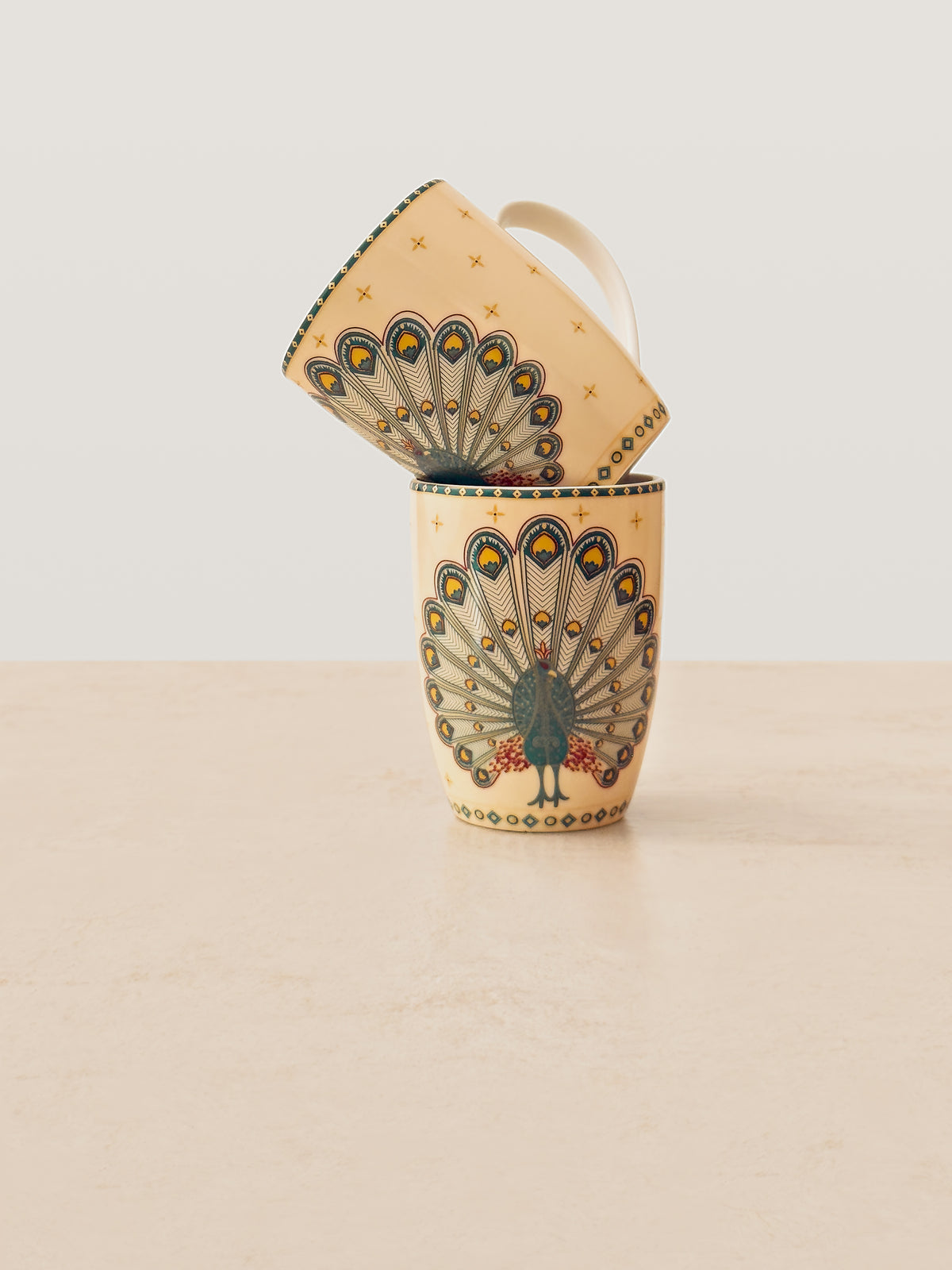 Mor Bagh Dusk porcelain coffee mugs stacked, showing the peacock tail print