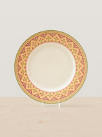 Mor Bagh Dawn porcelain dinner plate on a stand, wide pink and gold patterned rim with a plain centre