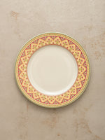 Mor Bagh Dawn dinner plate from above, showing the pink and gold border on a stone background