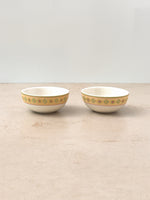 Two Mor Bagh porcelain katoris in Dawn with a printed border, side by side on a stone surface