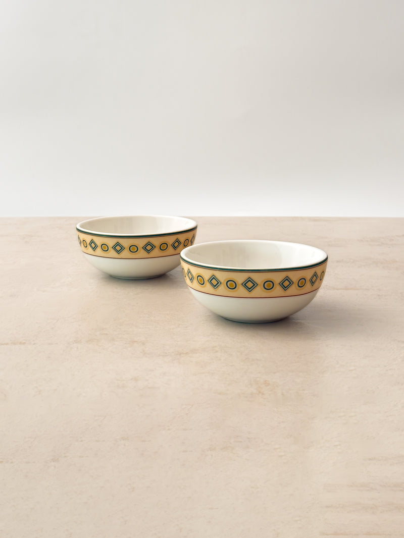 Pair of Mor Bagh Dusk porcelain katori bowls on a stone counter, angled view showing the rim