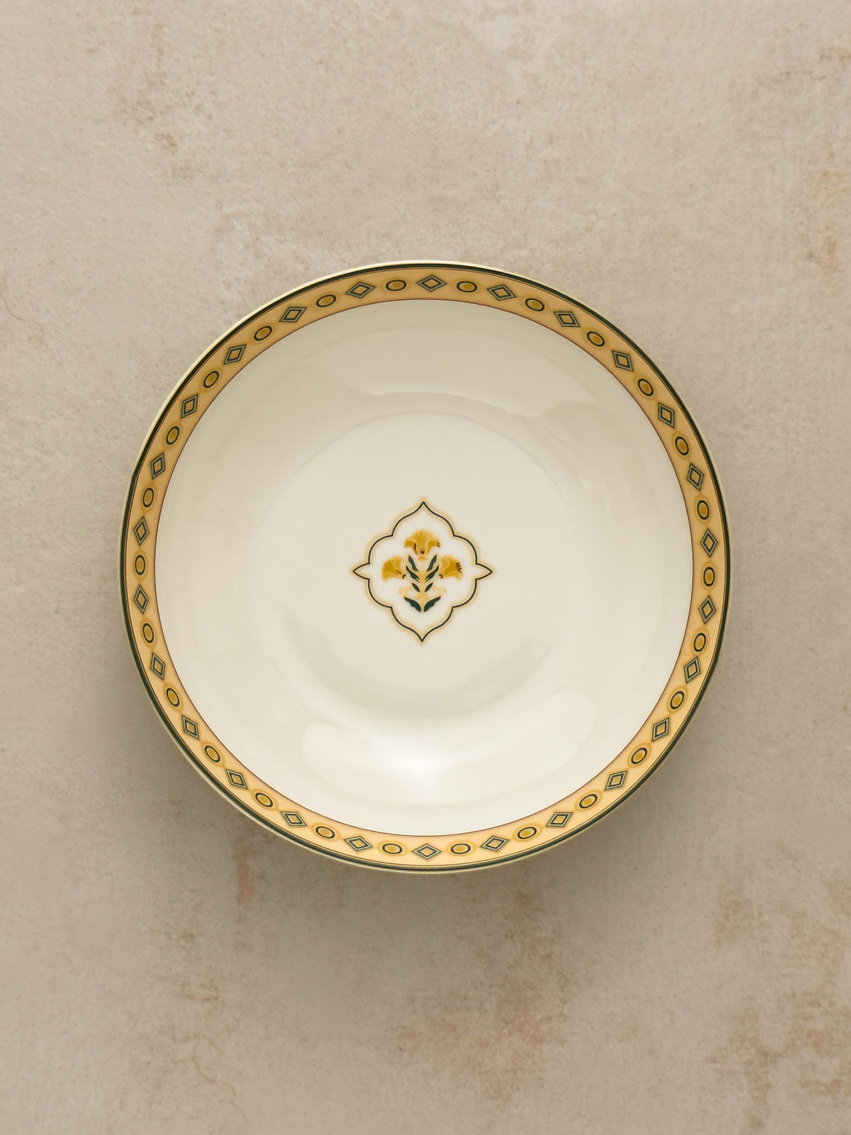 Mor Bagh Dusk serving bowl from above with a green and gold border and a small centre motif