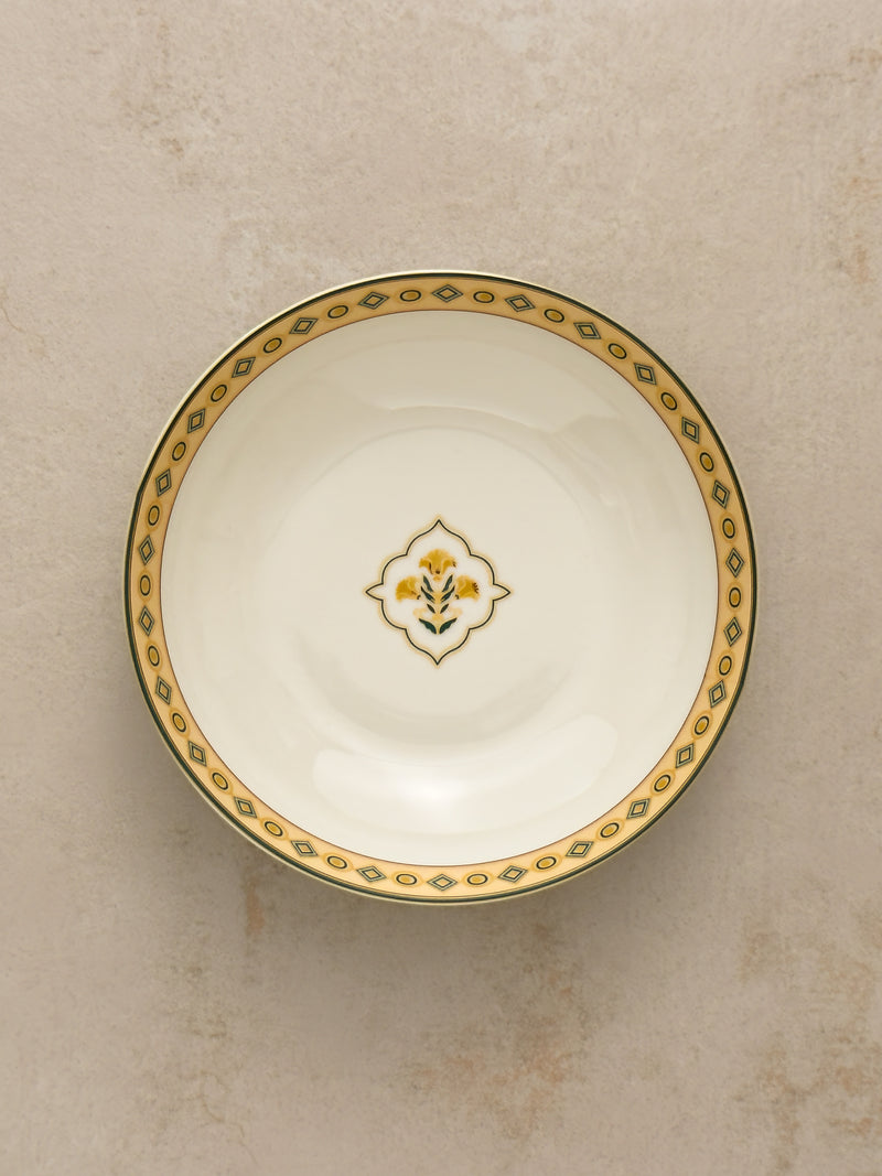 Mor Bagh Dusk serving bowl from above with a green and gold border and a small centre motif