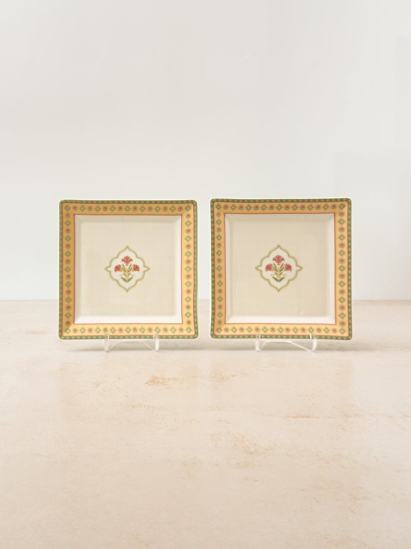 Two Mor Bagh Dawn porcelain square platters on stands, gold border and a small centre motif