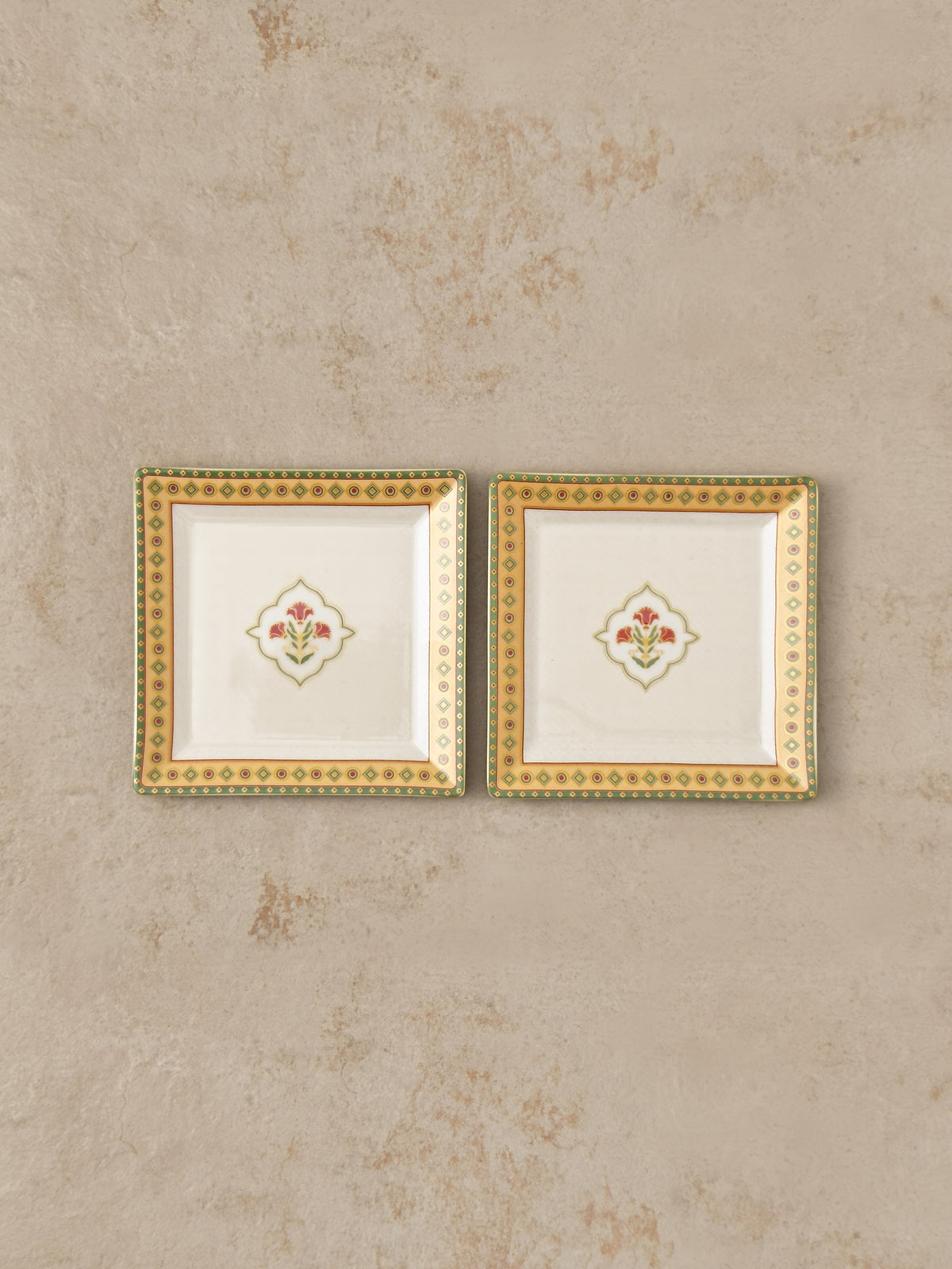 Pair of Mor Bagh Dawn square platters from above, side by side on stone