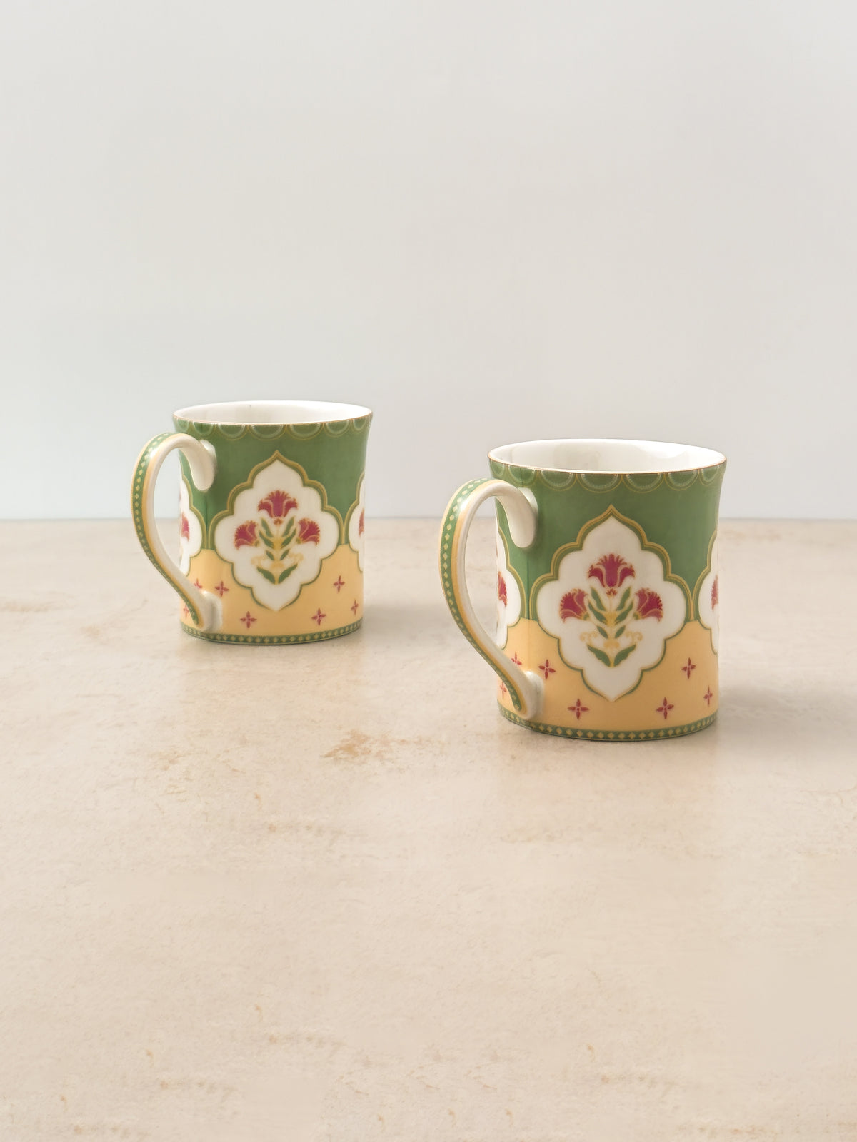 Pair of Mor Bagh Dawn tea mugs turned to show the handles and side print
