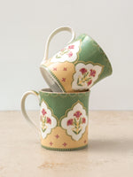 Mor Bagh Dawn porcelain tea mugs stacked, showing the lotus print and curved handle