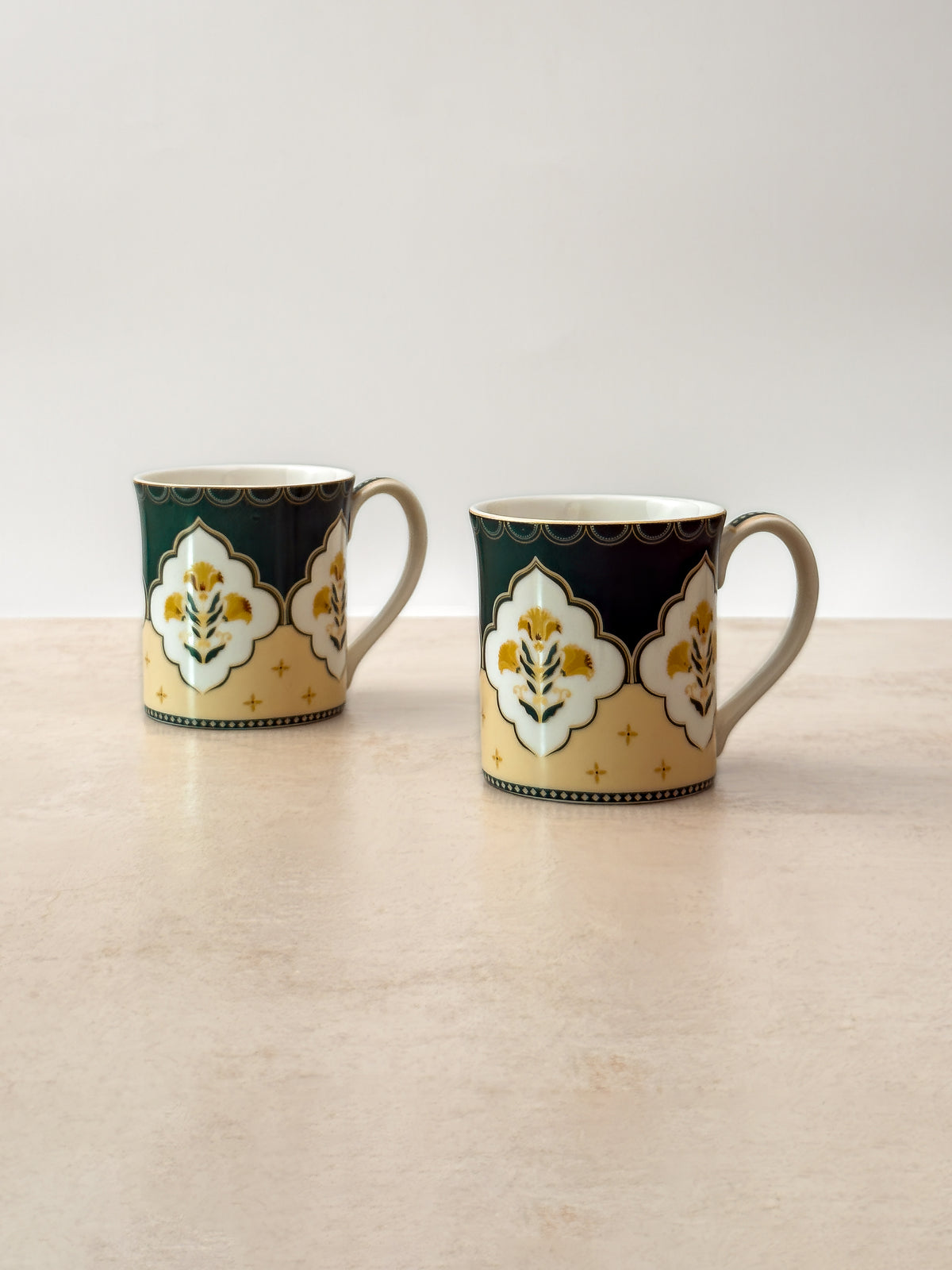 Pair of Mor Bagh Dusk tea mugs side by side on a stone surface, handles facing out