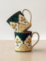 Mor Bagh Dusk porcelain tea mugs stacked, showing the dark green print and lotus motif