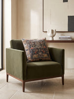 Black slub print cushion on an olive green velvet armchair