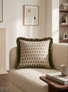 Green frill square cushion with a small green print on a cream armchair