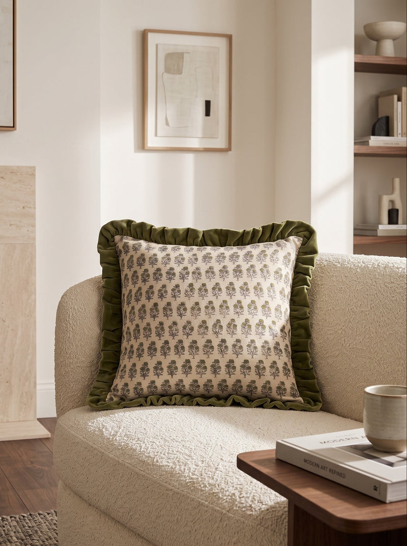 Green frill square cushion with a small green print on a cream armchair