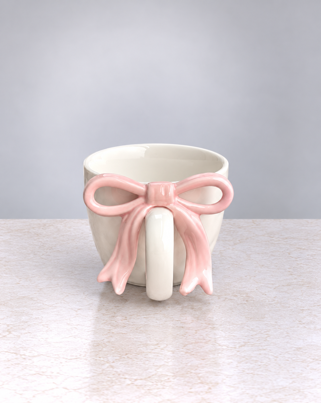 Blush pink ribbon bow ceramic mug, front view of the bow