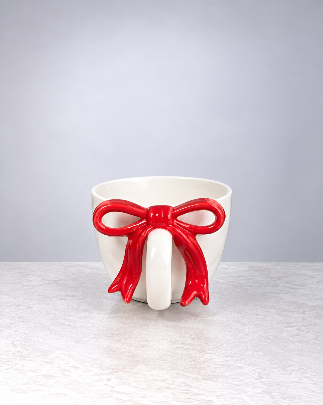 Cherry red ribbon bow ceramic mug, front view of the bow